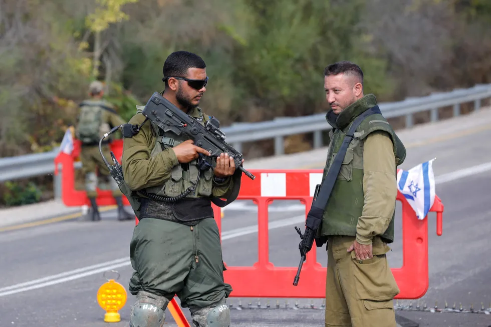 Israeli soldiers man a checkpoint near the northern Kibbutz Sasa close to the border with Lebanon on 17 October.