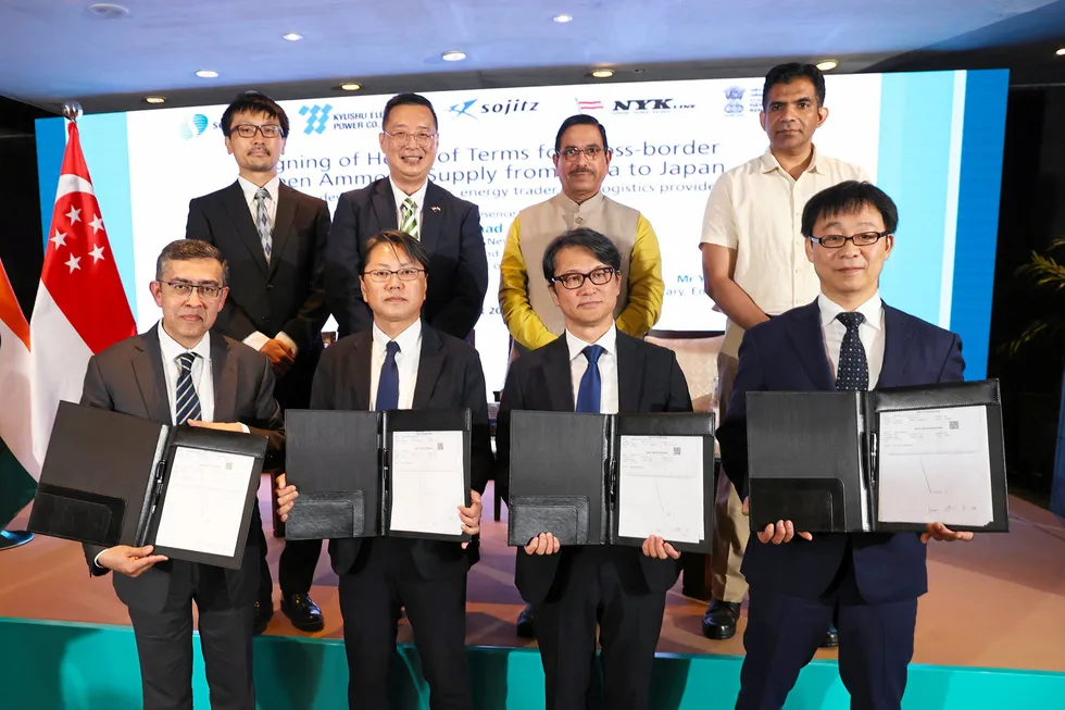 A signing ceremony between Sembcorp, NYK, Sojitz, and Kyushu Electric Power executives, with Indian renewable energy minister Pralhad Joshi (second from right in top row).