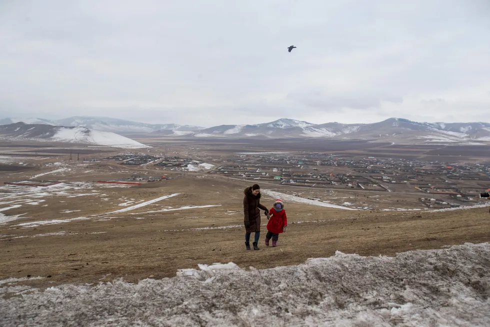 Leading the way: A girl walks with her mother in Bornuur Sum, a village 135 kilometres away from Ulaanbaatar, the capital of Mongolia