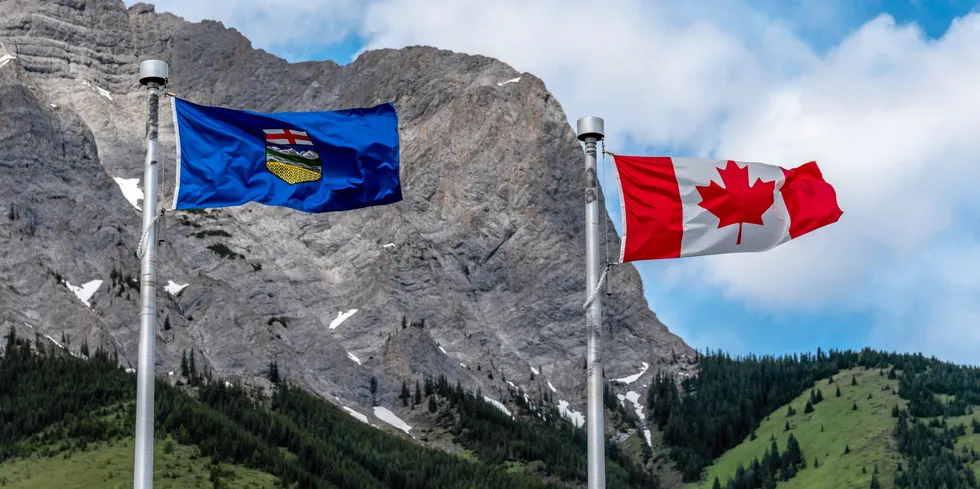 Canadian and Alberta flags waiving on a beautiful summer day in Kananaskis. . Canada Alberta flag.