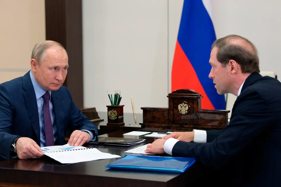 Budget troubles: Russian President Vladimir Putin (left) and Trade Minister Denis Manturov.