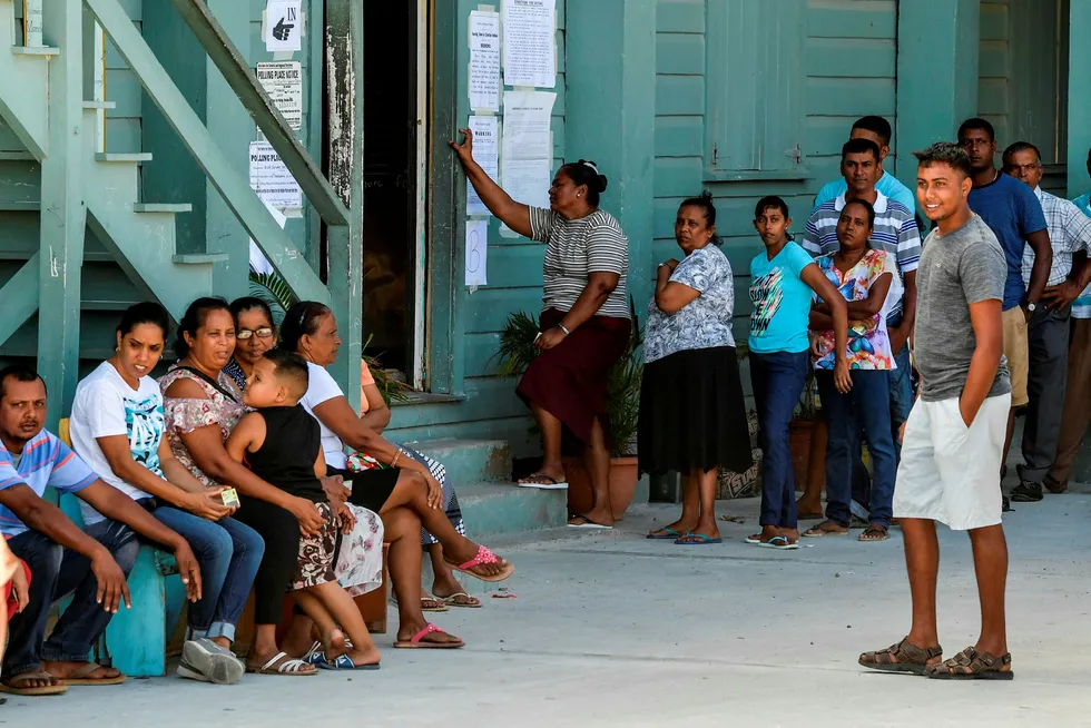 Lining up: Guyanese citizens wait to cast their votes in elections