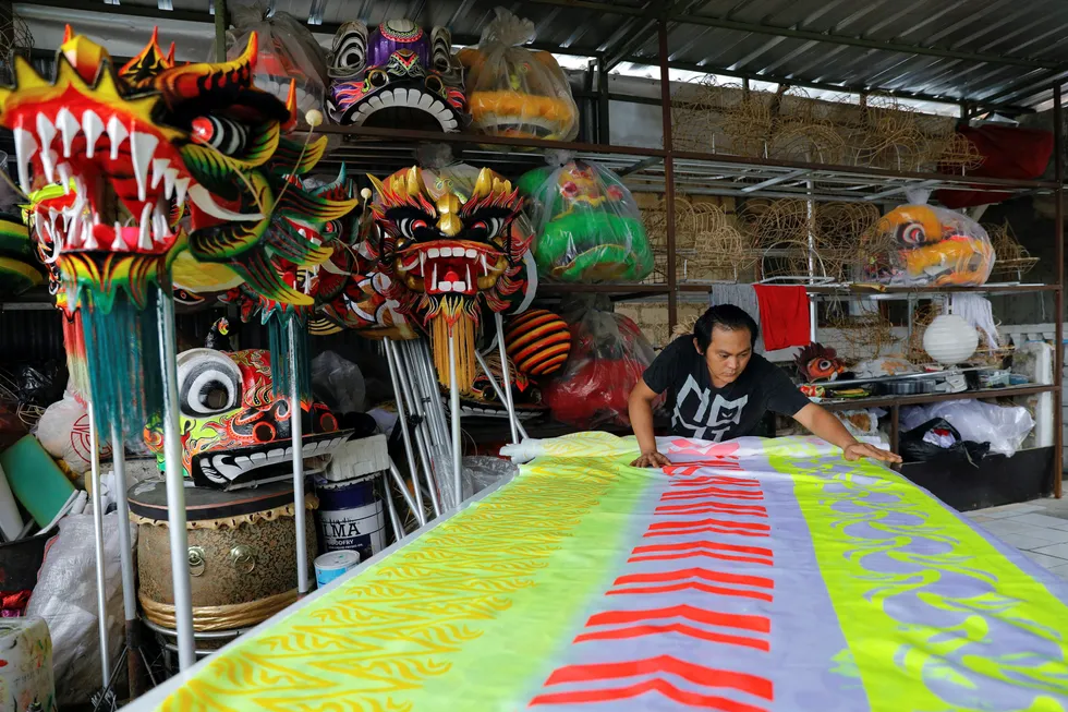Time for celebration: a craftsman prepares a costume for the traditional dragon dance ahead of the Chinese Lunar New Year in Java, Indonesia