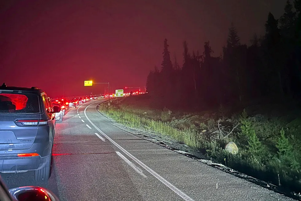 This photo, provided by Carolyn Campbell, shows cars clogging the highway as people evacuate because of wildfires early Tuesday, 23 July 2024, in Jasper, Alberta.