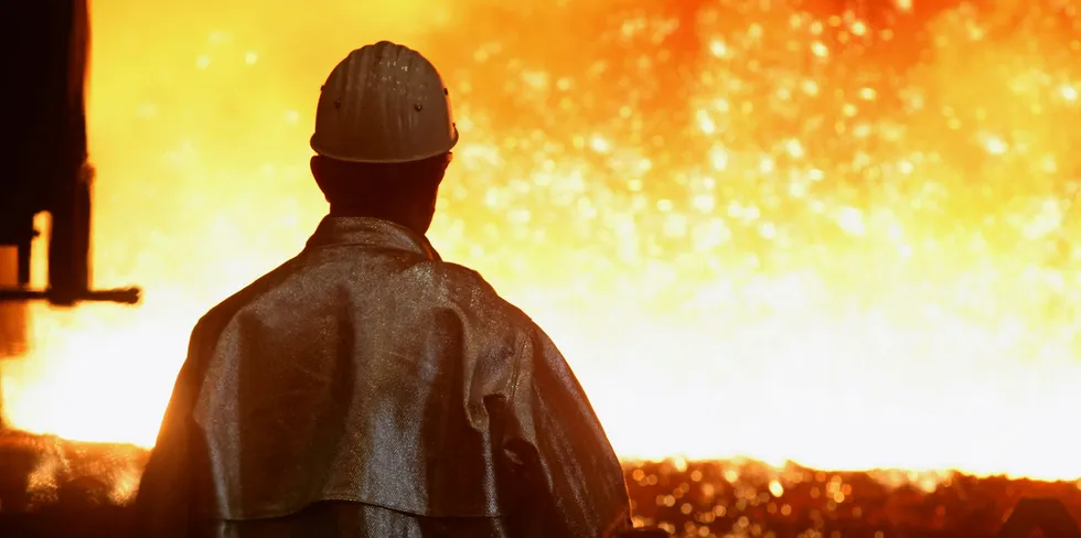 A worker looks into the blast furnace at Thyssenkrupp's steelworks in Duisberg, Germany.