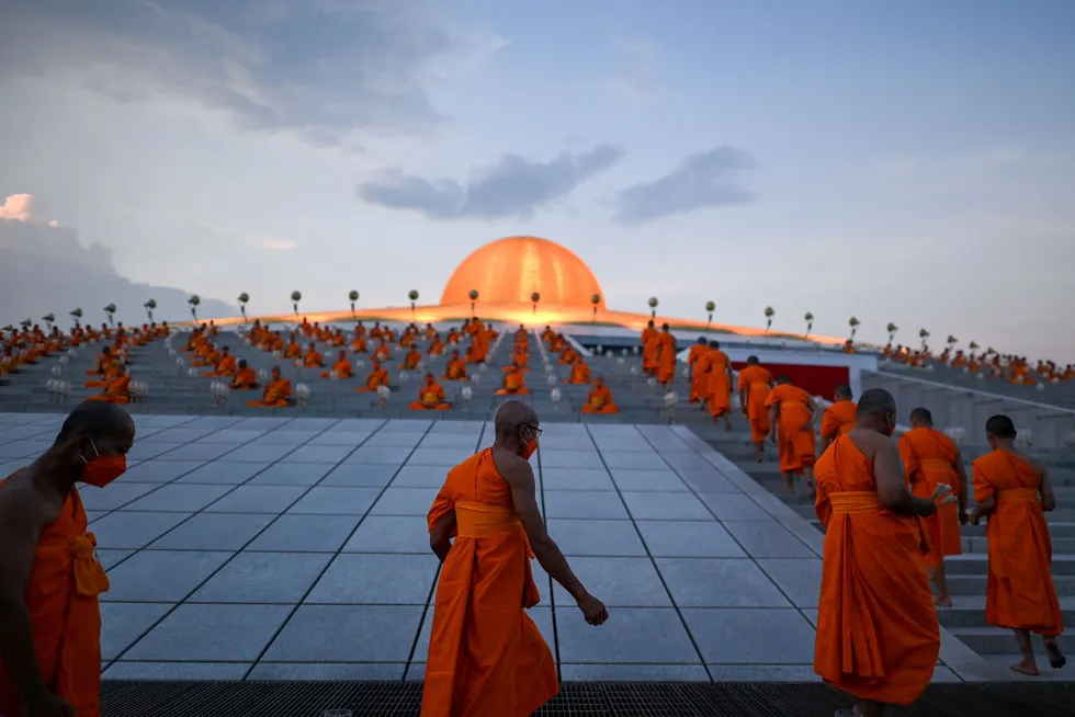 Celebration: Buddhist monks arrive to take part in Earth Day celebrations at the Wat Dhammakaya Buddhist temple in Pathum Thani province, north of Bangkok, Thailand on 22 April