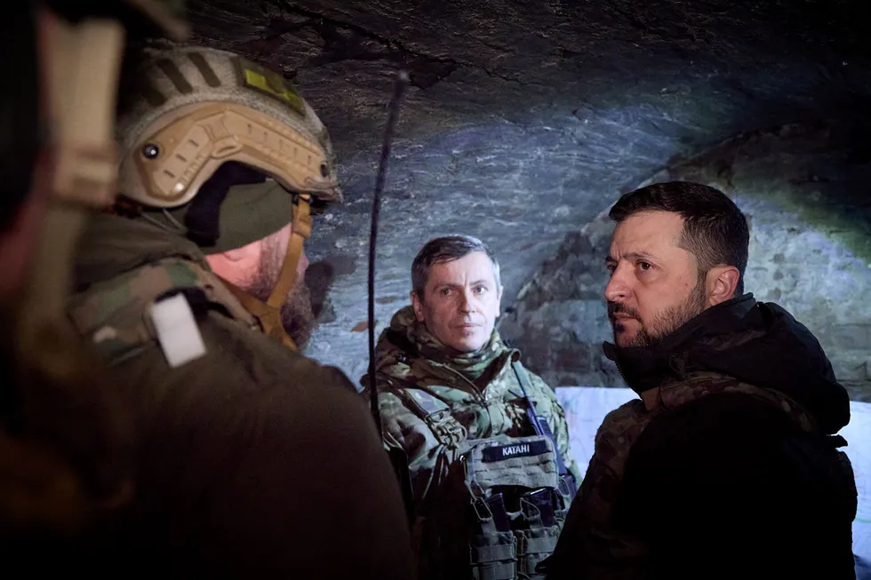 Ukraine President Volodymyr Zelensky (right) talks with a serviceman during a visit to the country’s Zaporizhzhia region.