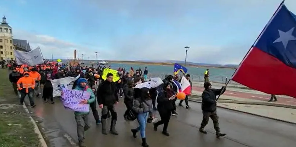 Protestors march against a new law that would severely restrict salmon farming in the Southern area of Chile.