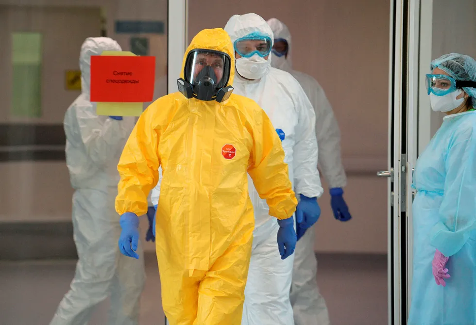 Facing the threat: Russian President Vladimir Putin, wearing a yellow protective suit, enters a hospital for coronavirus patients in the Kommunarka settlement near Moscow, Russia, on the eve of his address to the nation