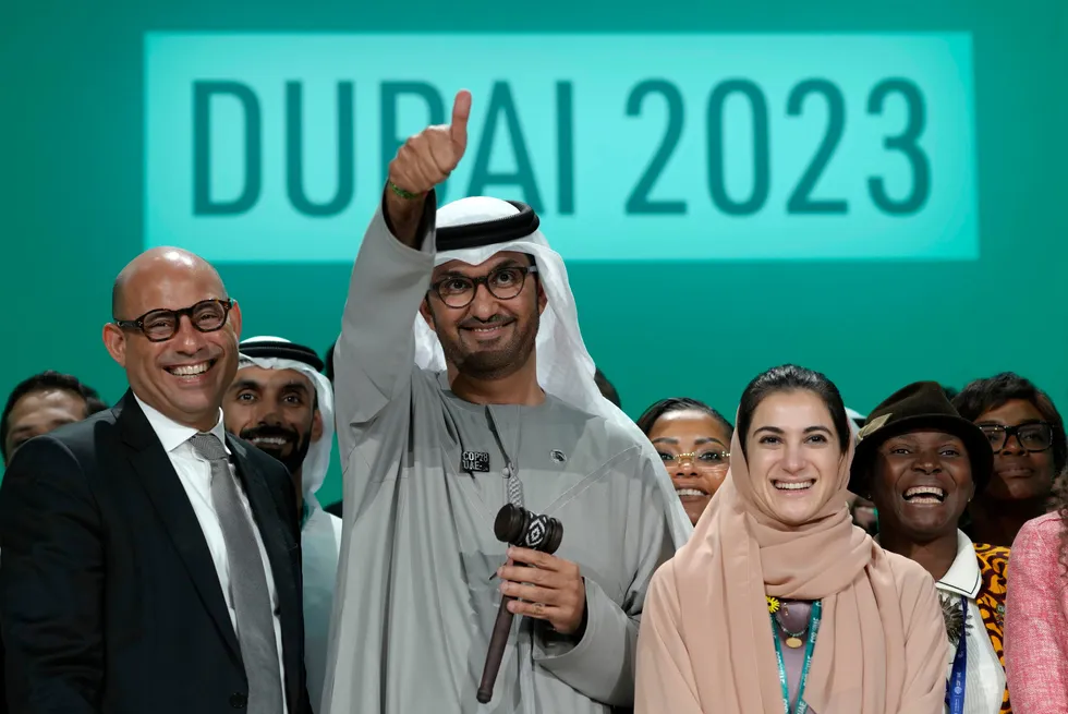 United Nations Climate Chief Simon Stiell (left), with COP28 President Sultan Al Jaber (centre) and UAE chief COP28 negotiator Hana Al-Hashimi pose for photos at the end of the climate summit in Dubai.