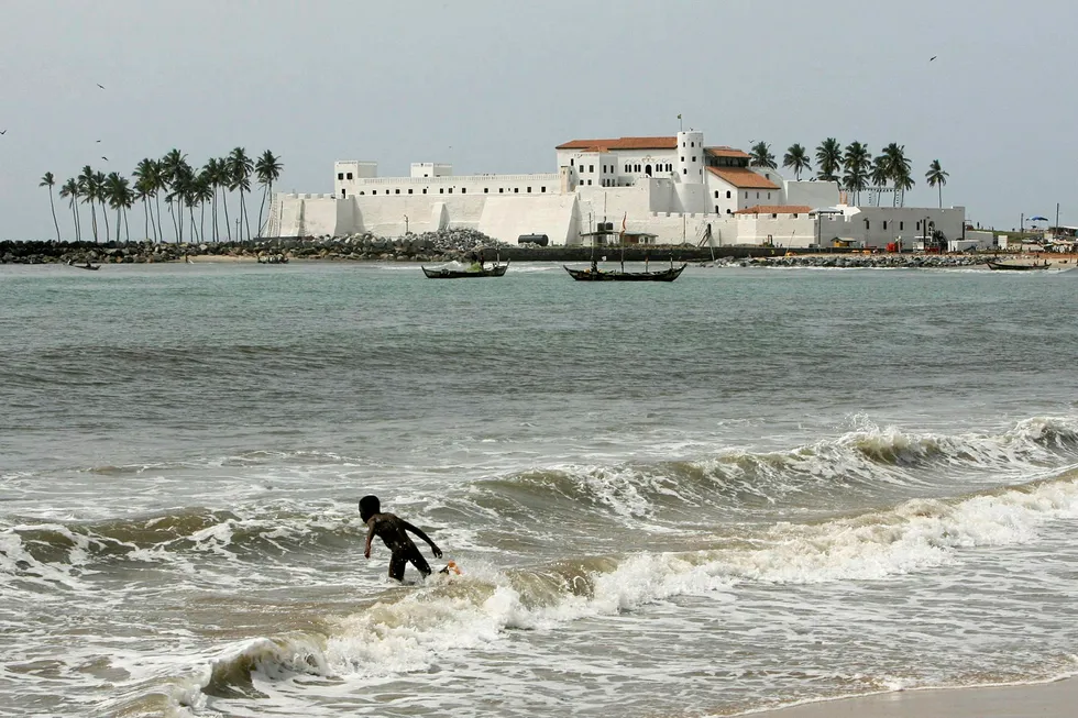 Testing the waters: a youth about to dive into the sea near Elmina Castle in Cape Coast, Ghana