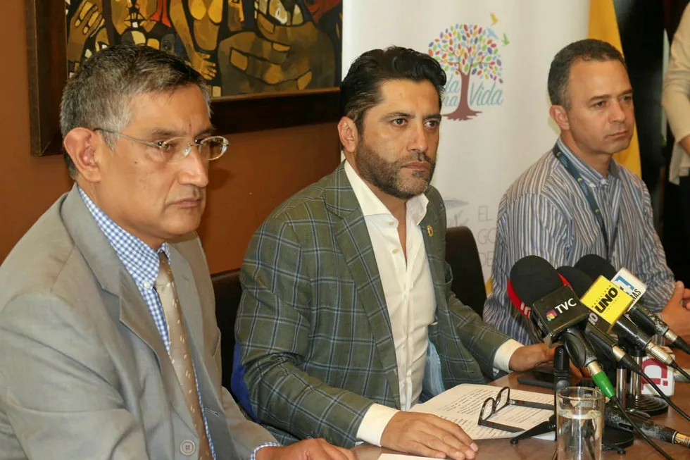 Ecuadorian Minister Ivan Ontaneda (center) at press conference.