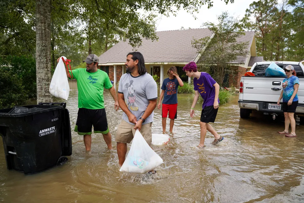 Damage: people clean up a home flooded by Hurricane Ida in Ponchatoula, Louisiana