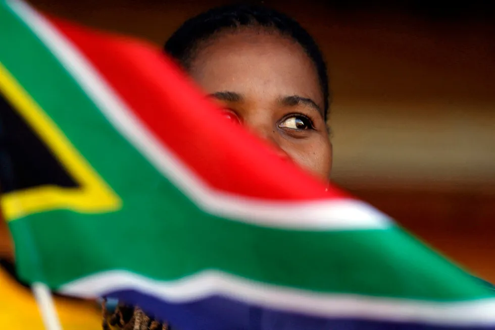 In focus: A woman waves a South African flag near Johannesburg.