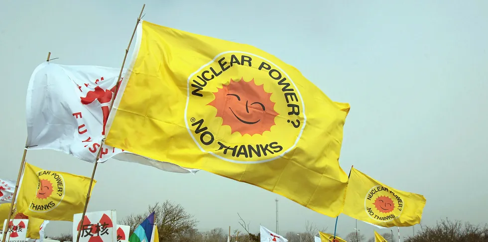 Anti nuclear protesters listen to speakers at the gates to the Hinkley Point nuclear power station.