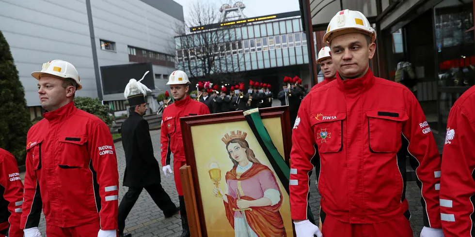 Coal miners from the KWK Pniowek coal mine prepare to carry a painting of Saint Barbara on Barborak, their annual day of tribute to Barbara, from the mine to their local church in Pawlowice, Poland. The mines, many of them in the region of Silesia, employ tens of thousands of workers.