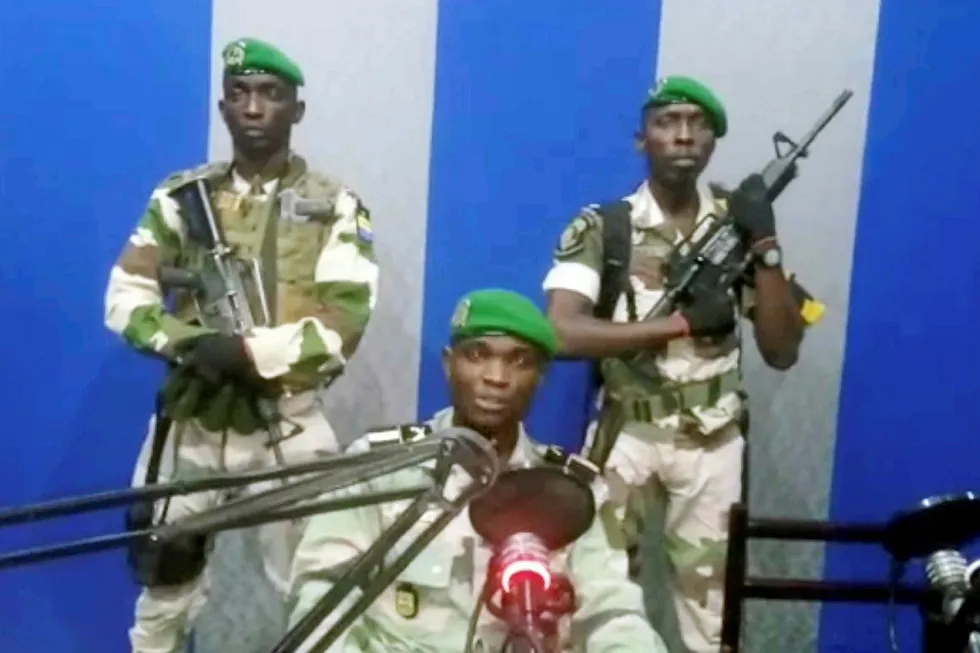 Broadcast: a still image taken from a video showing military officers delivering a statement from a radio station in Gabon during the attempted coup