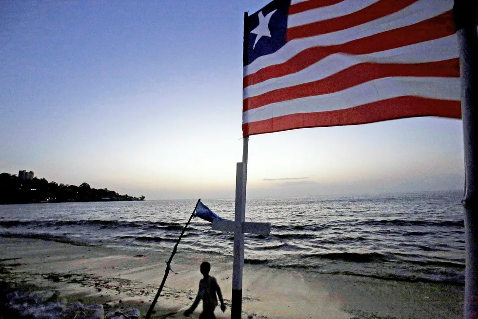 Looking offshore: a boy walks on the beach at Monrovia. Liberia is at the centre of a recent GW report