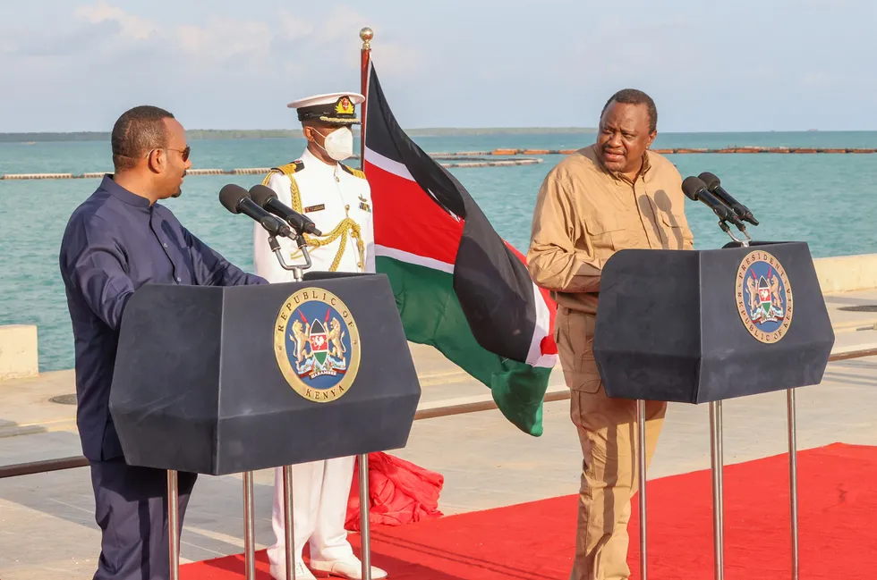 Loggerheads: Kenya's President Uhuru Kenyatta (right) addresses the media at Lamu port - close to the maritime boundrary with Somalia - in December 2020