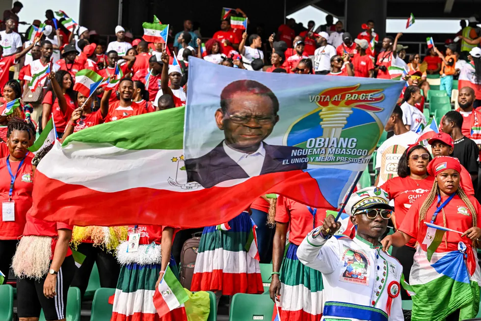 Equatorial Guinea supporters hold flags ahead of a football match in the Ivory Coast in January 2024.