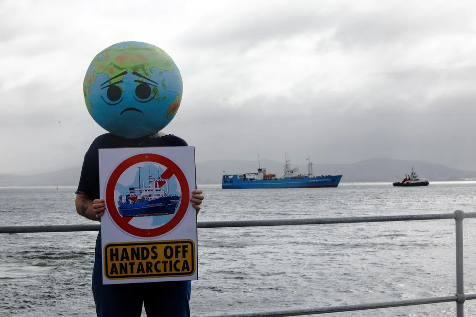 Protests: a member of the Extinction Rebellion environmental group holds up a placard as Akademik Karpinsky, a Russian research vessel, arrives in Cape Town harbour in South Africa at the end of January 2023.