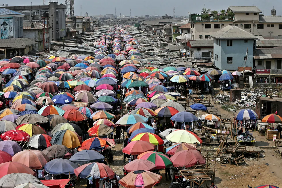 Next step: traders sell goods beneath umbrellas at the Mile One open market in Port Harcourt, Nigeria
