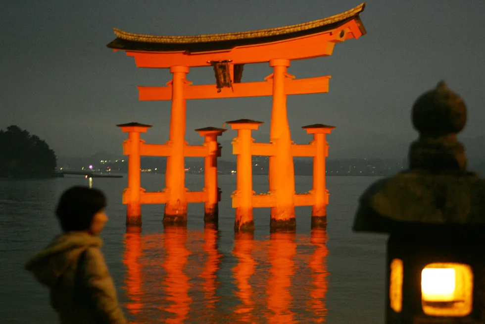 Illuminated: the grand gate Otorii of the world cultural heritage Itsukushima Shinto shrine in Miyajima near Hiroshima
