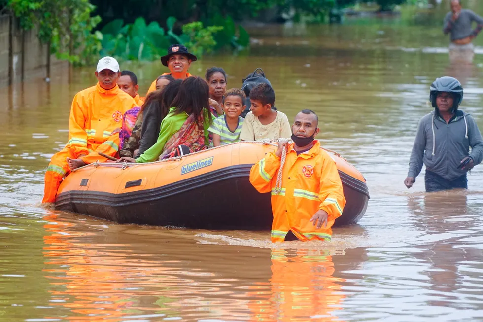 Tropical cyclone: rescue workers evacuate people through the water in an area affected by floods after heavy rains in Dili, East Timor, last week