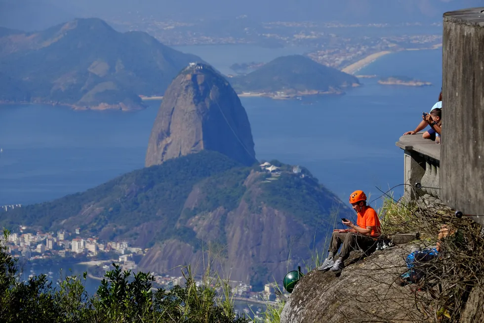 Brazil floater job: a climber rests on the edge of Corcovado mountain, Rio de Janeiro