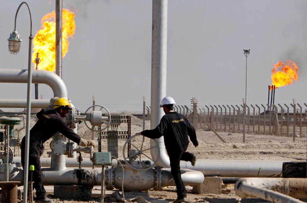 Oil workers at the West Qurna 1 field in Basra, Iraq