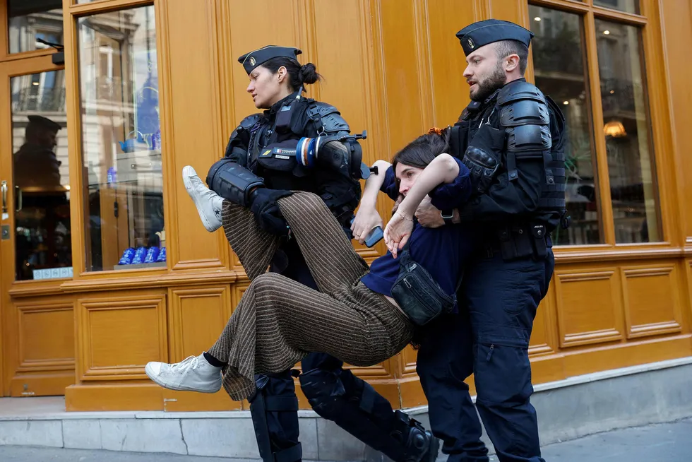 A climate protester is being evacuated by French gendarmes during a demonstration on the outskirts of the Paris venue for TotalEnergies Annual General Meeting in Paris on Friday.