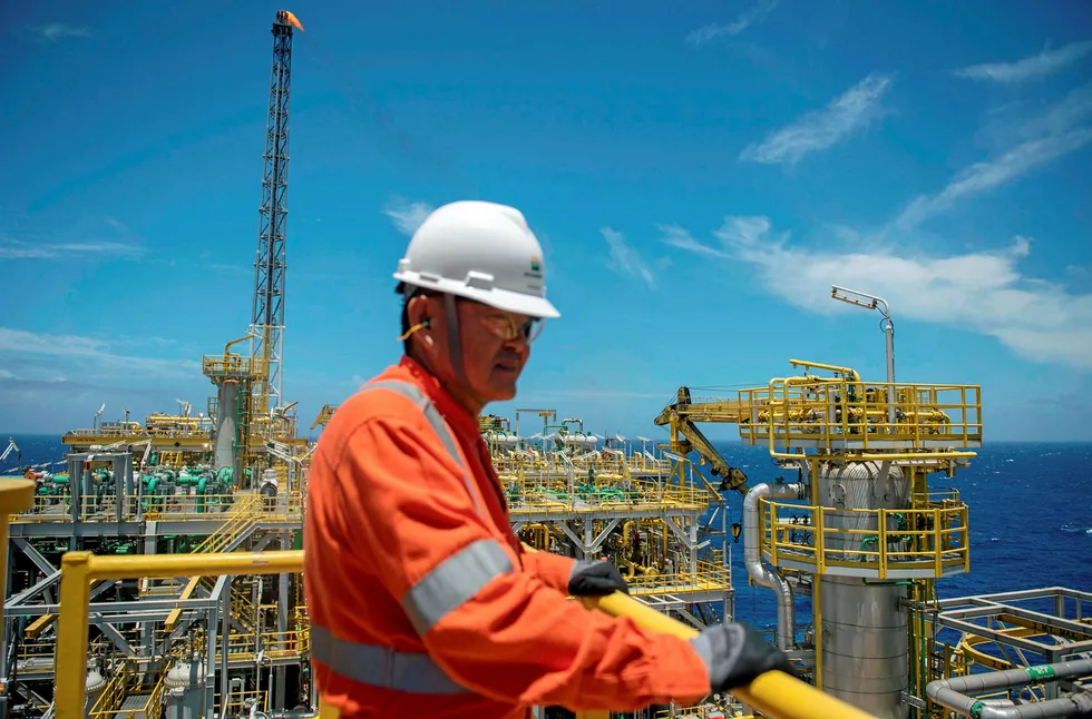 Up and running: a worker aboard the Cidade de Itaguai FPSO in the Santos basin. Petrobras is looking to charter up to three more units for its developments