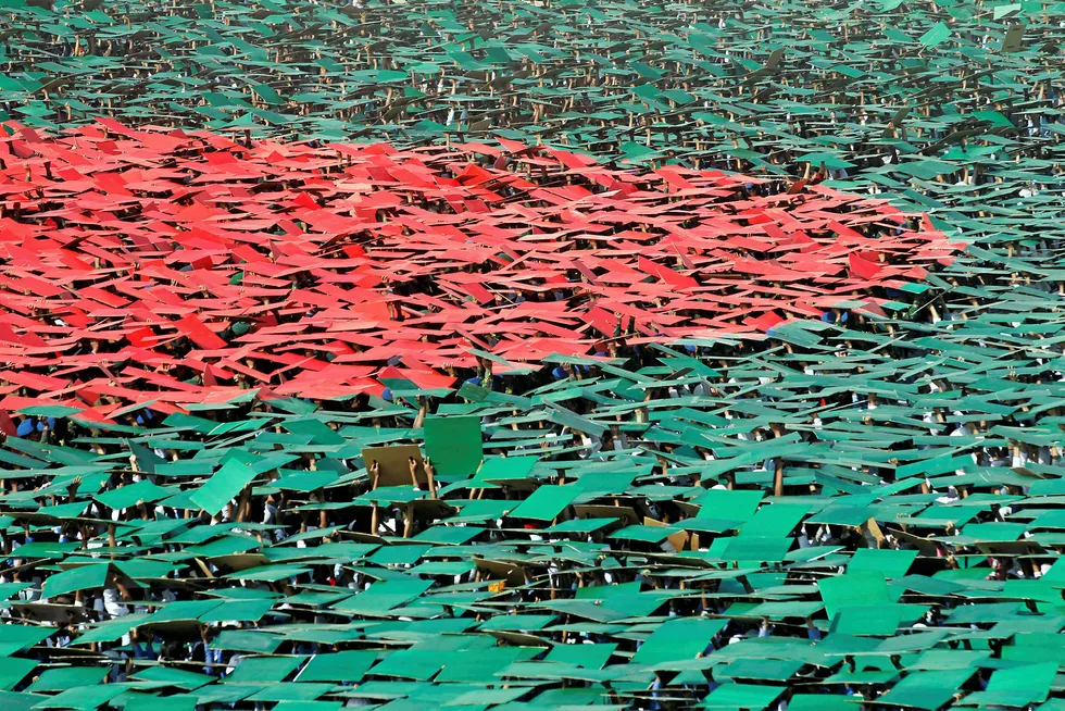 On parade: volunteers prepare to form a large flag of Bangladesh during a national celebration