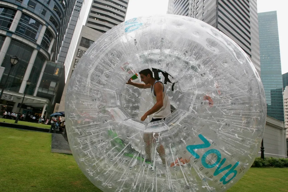 Gaining momentum: a man walks inside an inflatable air-cushioned ball in Singapore's Central Business District.