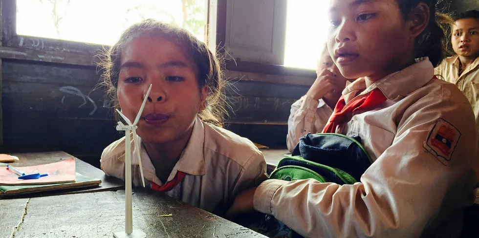 Children in Laos with wind turbine model