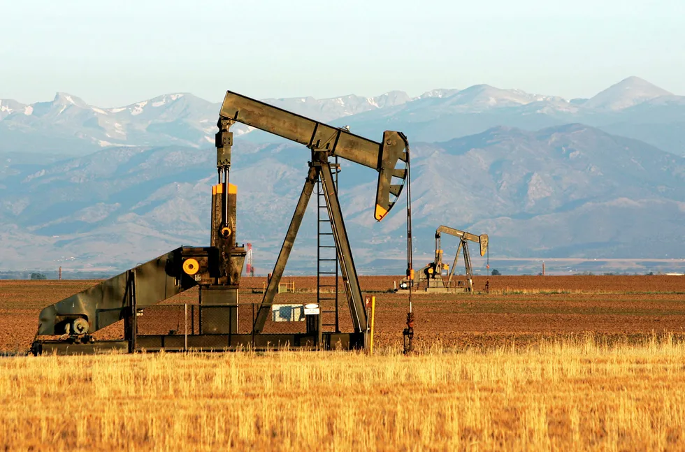 An oil well is seen at dawn near Dacono, Colorado