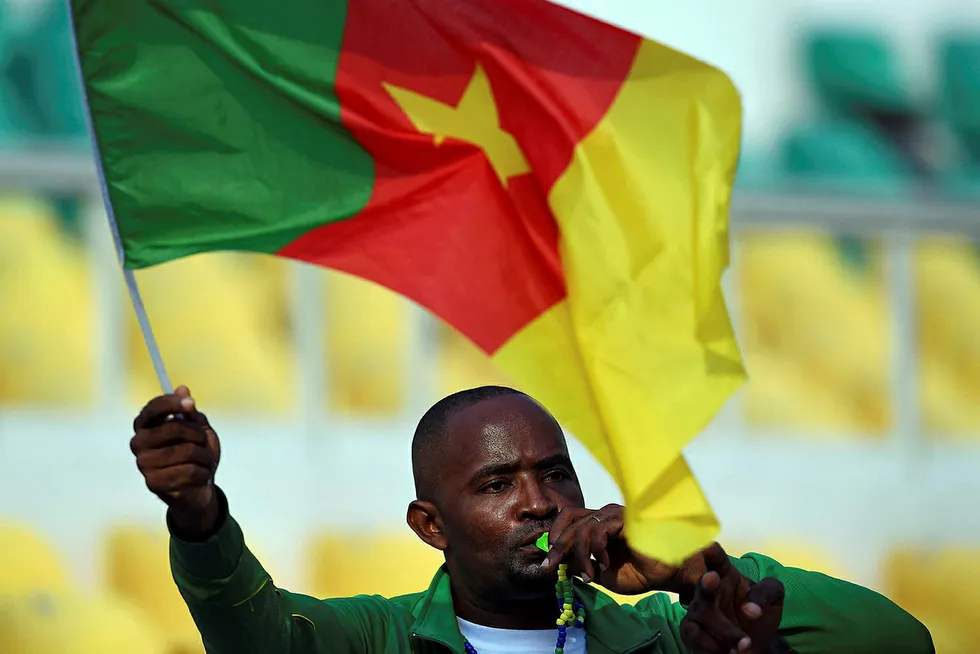 A Cameroon supporter waves a Cameroonian flag ahead of the 2017 Africa Cup of Nations final football match between Egypt and Cameroon at the Stade de l'Amitie Sino-Gabonaise in Libreville on February 5, 2017. / AFP PHOTO / GABRIEL BOUYS . .