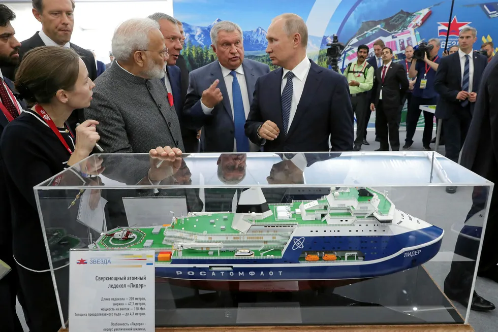Economic forum: Indian Prime Minister Narendra Modi and Russian President Vladimir Putin listen to Rosneft president Igor Sechin in Vladivostok, Russia