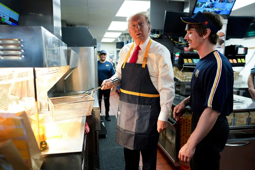 Republican presidential nominee former President Donald Trump works behind the counter during a visit to McDonald's in Feasterville-Trevose, Pa., Sunday, Oct. 20, 2024. (Doug Mills/The New York Times via AP, Pool)