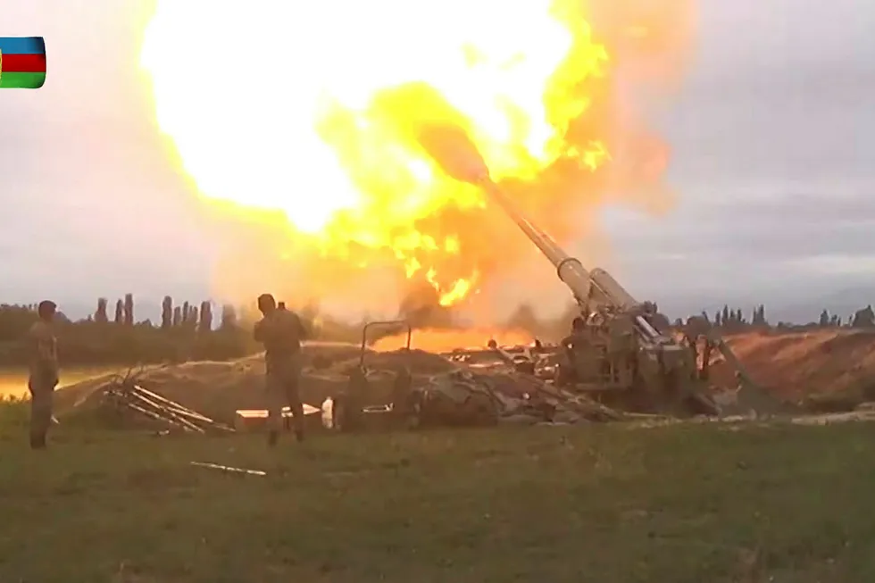 A still image from a video released by the Azerbaijan's Defence Ministry shows members of Azeri armed forces firing artillery during clashes between Armenia and Azerbaijan over the territory of Nagorno-Karabakh in an unidentified location, in this still image from footage released 28 September, 2020