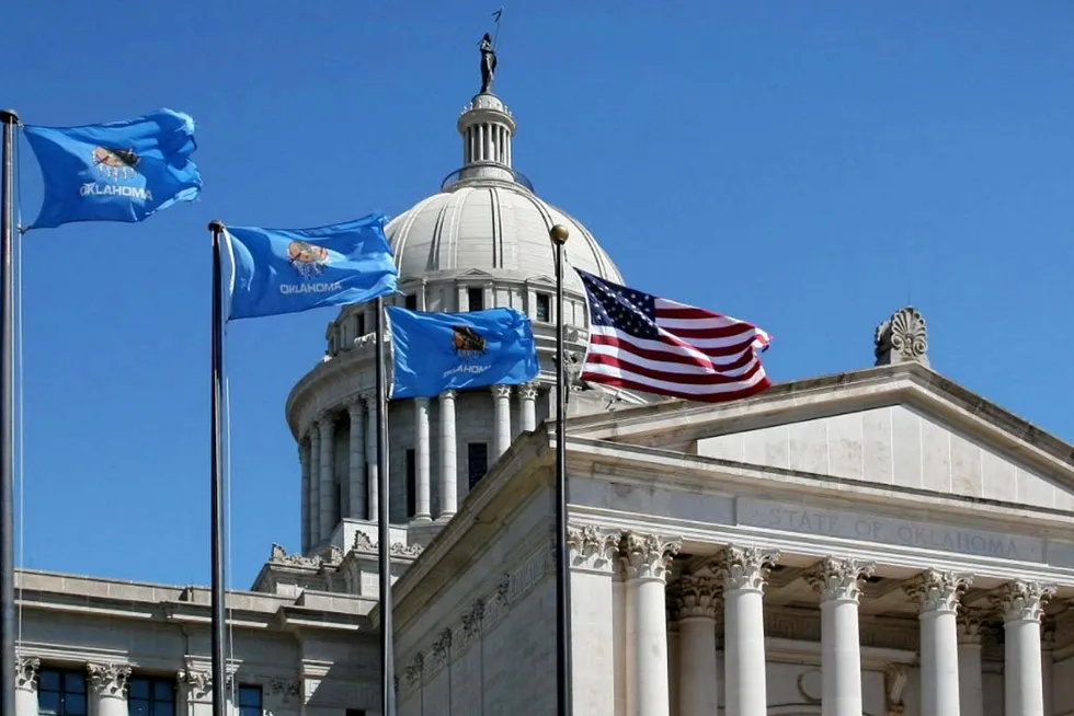 State and US flags flying at the Oklahoma State Capitol.