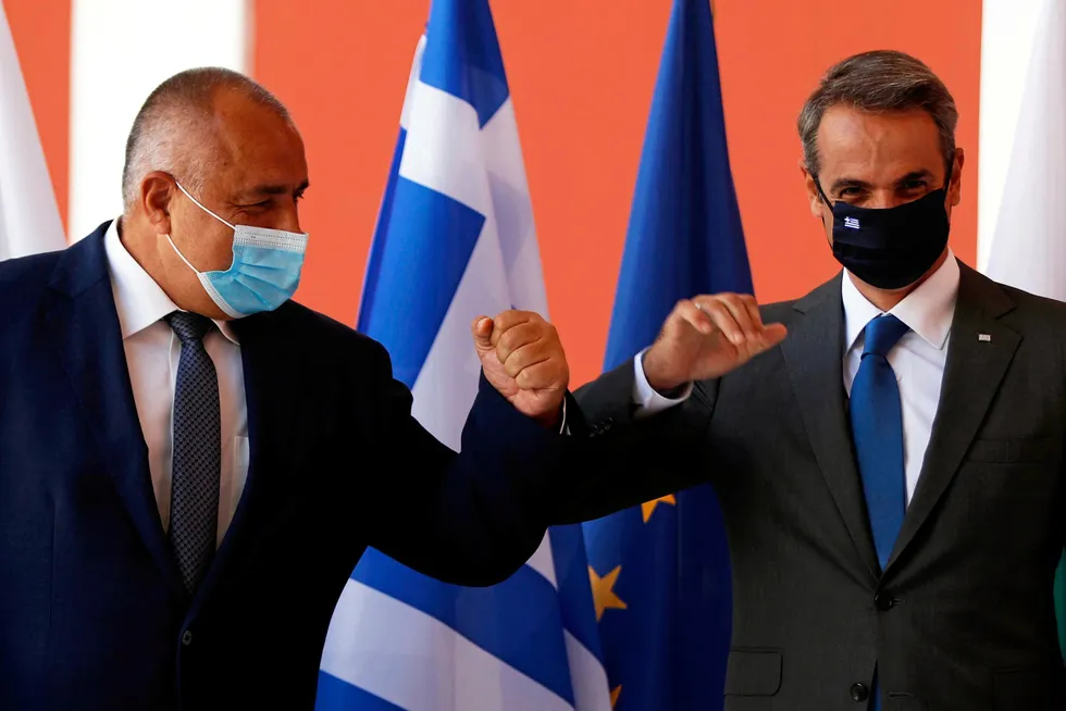 Flag day: Bulgarian Prime Minister Boiko Borissov (left) and Greek Prime Minster Kyriakos Mitsotakis (right) touch elbows before a signing ceremony for the Alexandroupolis LNG terminal project