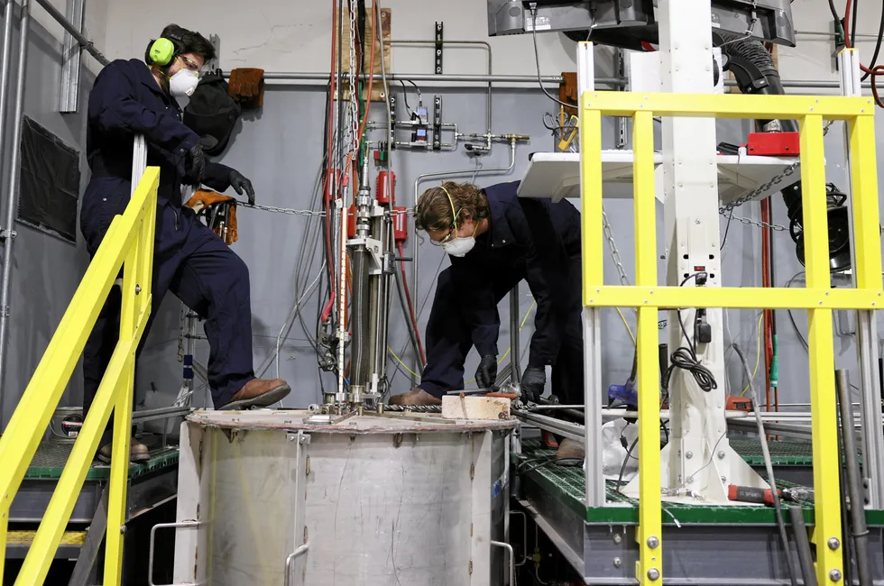 Research and development engineers working on a furnace at Boston Metal's facilities in Woburn, Massachusetts.