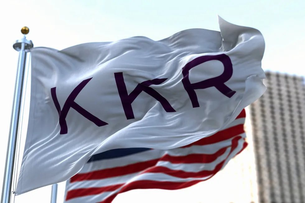 A flag with the corporate logo of KKR, alongside a US flag, in New York.