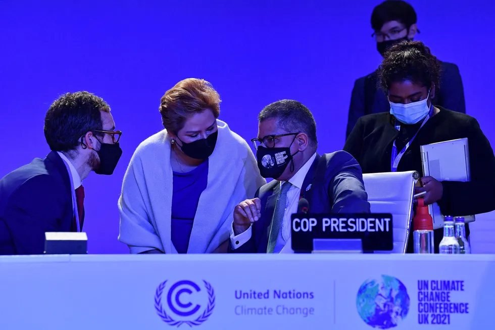 Unresolved issues: COP26 President Alok Sharma (centre) speaks with UNFCCC Executive Secretary Patricia Espinosa (second left) and other members of his team following an informal stocktaking session at the climate change summit on 12 November