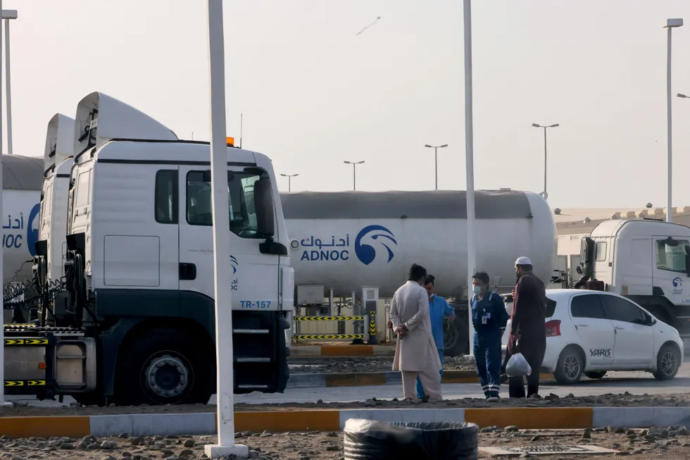 UAE attack: Men stand outside a storage facility of oil giant Adnoc in Abu Dhabi