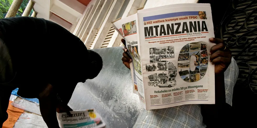 A man reads a newspaper in Tanzania.