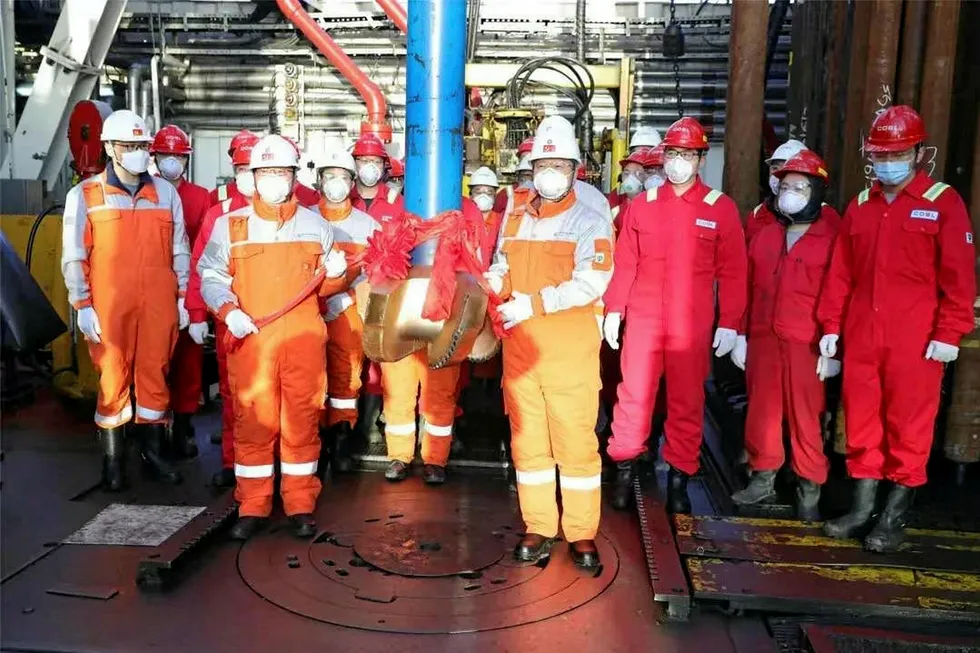Ready to spud: drilling crew post for picture on rig Hai Yang Shi You 941 before debut drilling started at Bozhong 19-6 gas play off northern China last week
