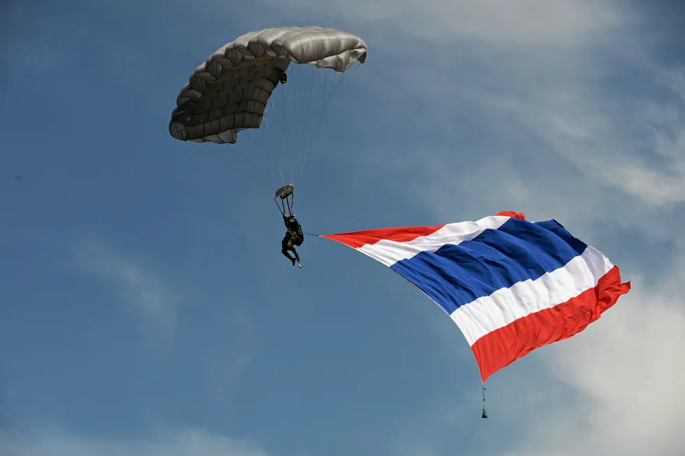 Flag day: a Thai soldier parachutes with a huge national flag
