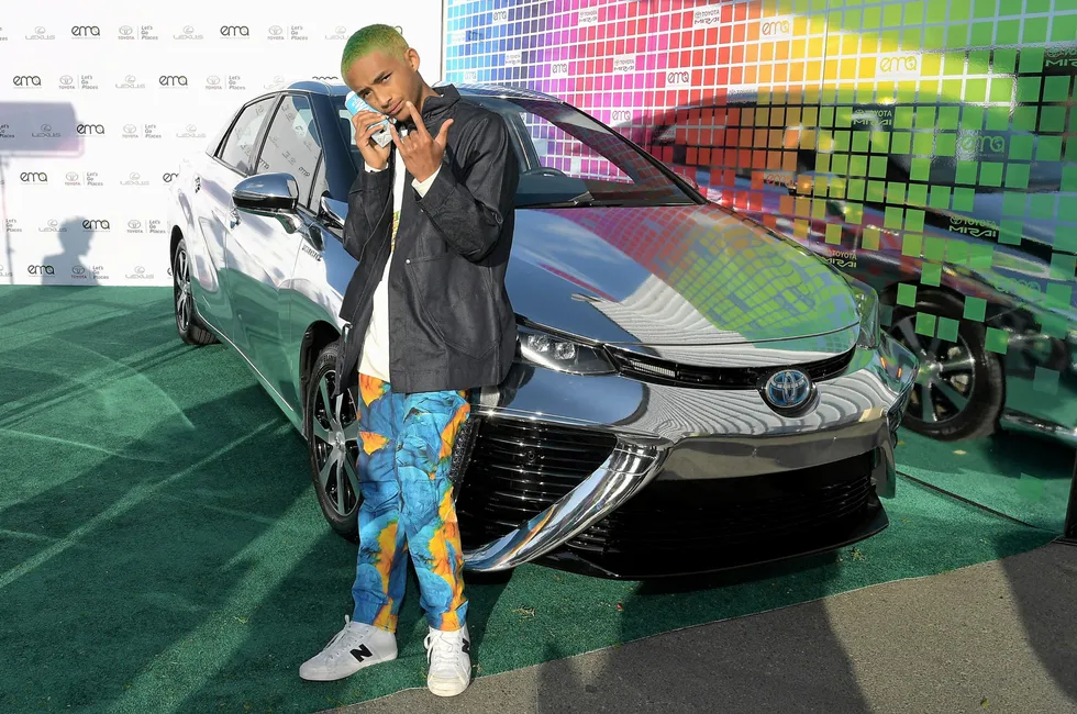Actor Jaden Smith posing in front of a mirrored Toyota Mirai fuel-cell car back in 2017.